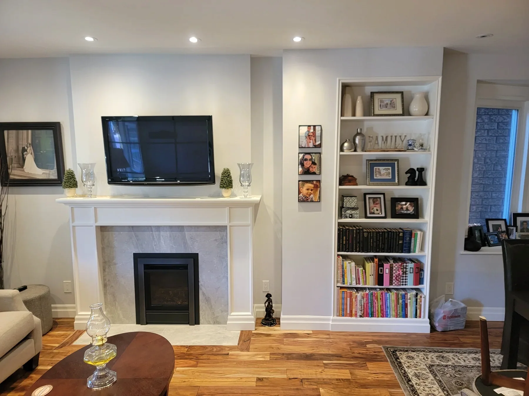 Ferreira interior renovation with built-in shelving, fireplace, and finished flooring